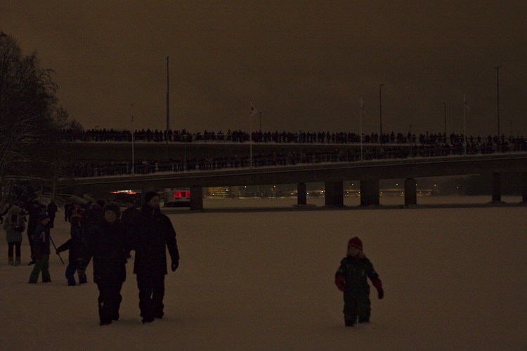 People on bridge watching